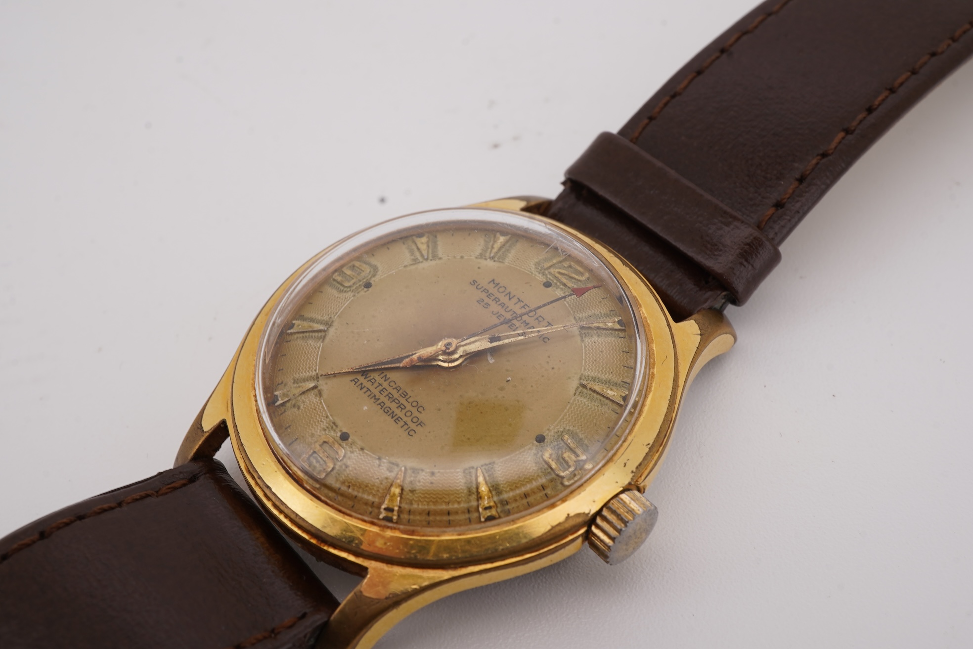A gentleman's steel and gold plated Montfort Superautomatic wrist watch, with Roman and quarterly Arabic numerals, case diameter 34mm, on a later associated leather strap.